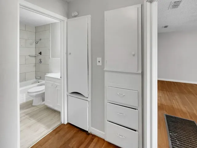 a bathroom with a granite countertop toilet and a shower