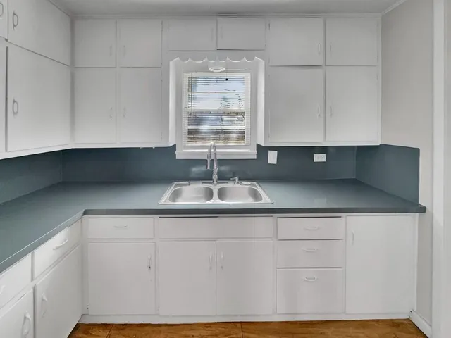 a kitchen with a sink and cabinets