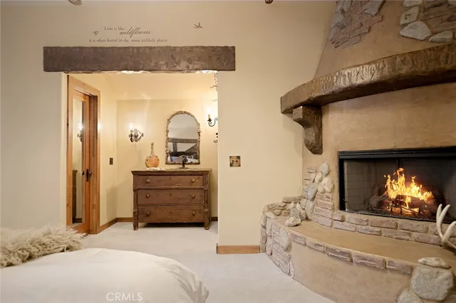 a bedroom with a bed and a fireplace
