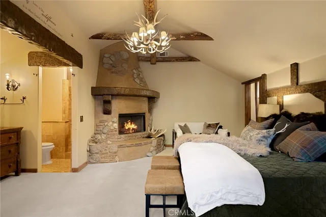 a spacious bedroom with a bed and a chandelier