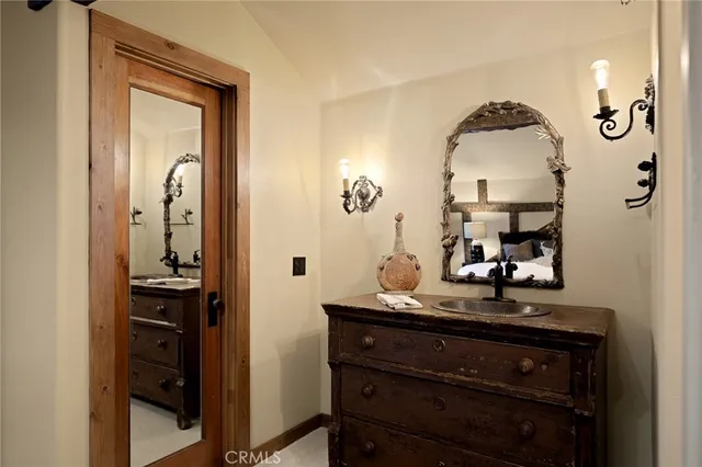 a bathroom with a sink a mirror and a vanity