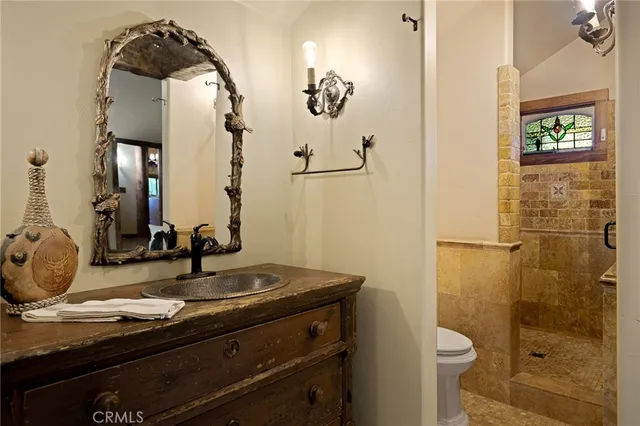 a bathroom with a granite countertop sink toilet and shower