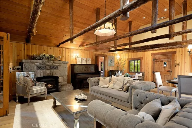 a living room with furniture a fireplace and a table