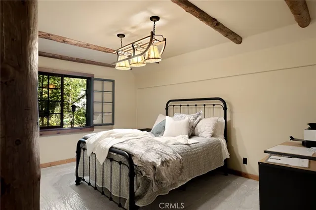 a bedroom with a bed and window