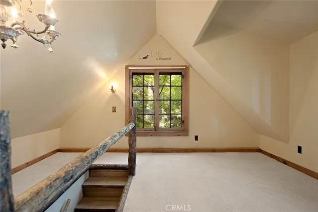 a view of a livingroom with wooden floor and a window