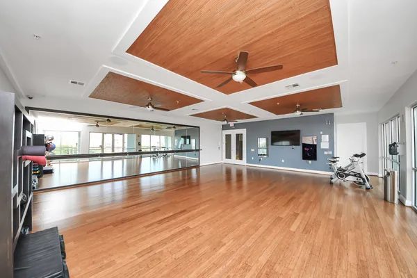 a living room with furniture flat screen tv and window