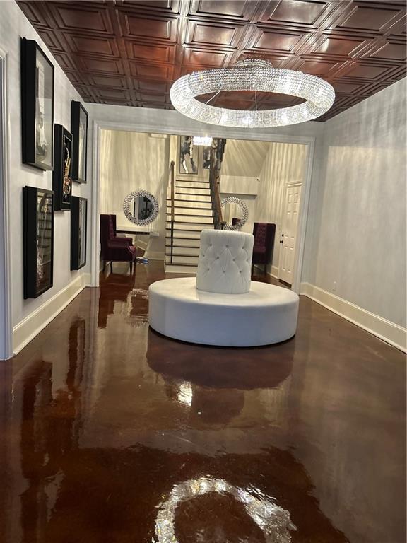 Undisclosed Address Milton, GA 30004 - Photo 103 of 118 a view of a dining room with furniture a kitchen and chandelier