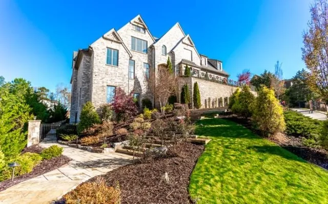a living room with lots of furniture tv and wooden floor
