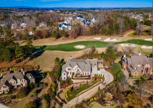 an aerial view of a house with a swimming pool