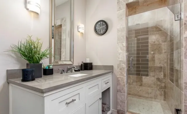a spacious bathroom with a granite countertop sink a toilet and a mirror