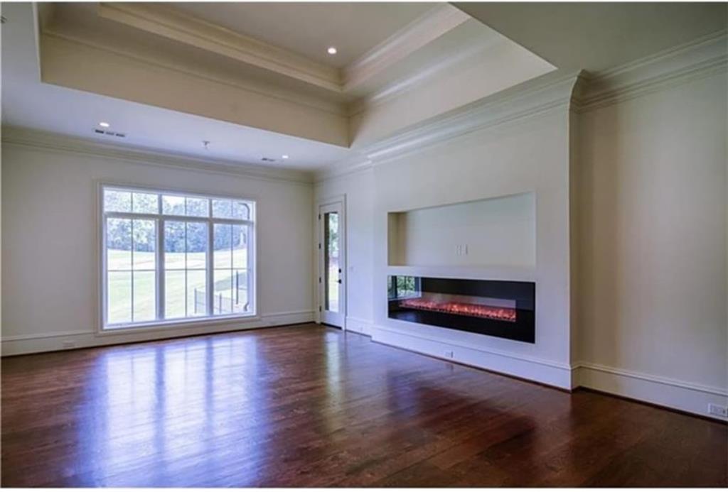 Undisclosed Address Milton, GA 30004 - Photo 74 of 118 a view of an empty room with window wooden floor and fire place