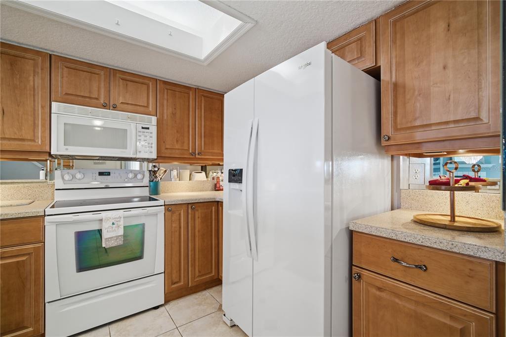 643 Garland Circle Indian Rocks Beach, FL 33785 - Photo 22 of 81 a kitchen with stainless steel appliances granite countertop a refrigerator stove and sink