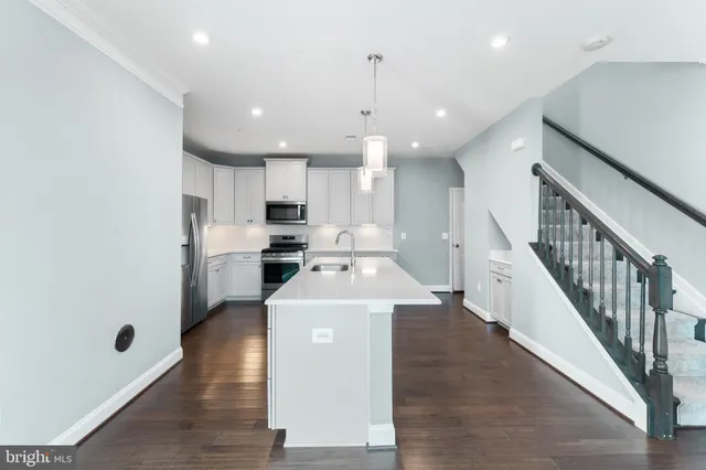 a view of a kitchen with cabinets and wooden floor