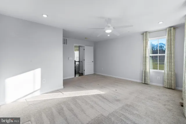 an empty room with windows and entrance