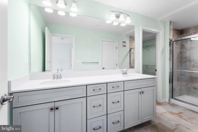 a bathroom with double sink and a mirror