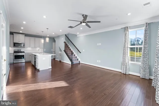 a view of kitchen with cabinets and wooden floor