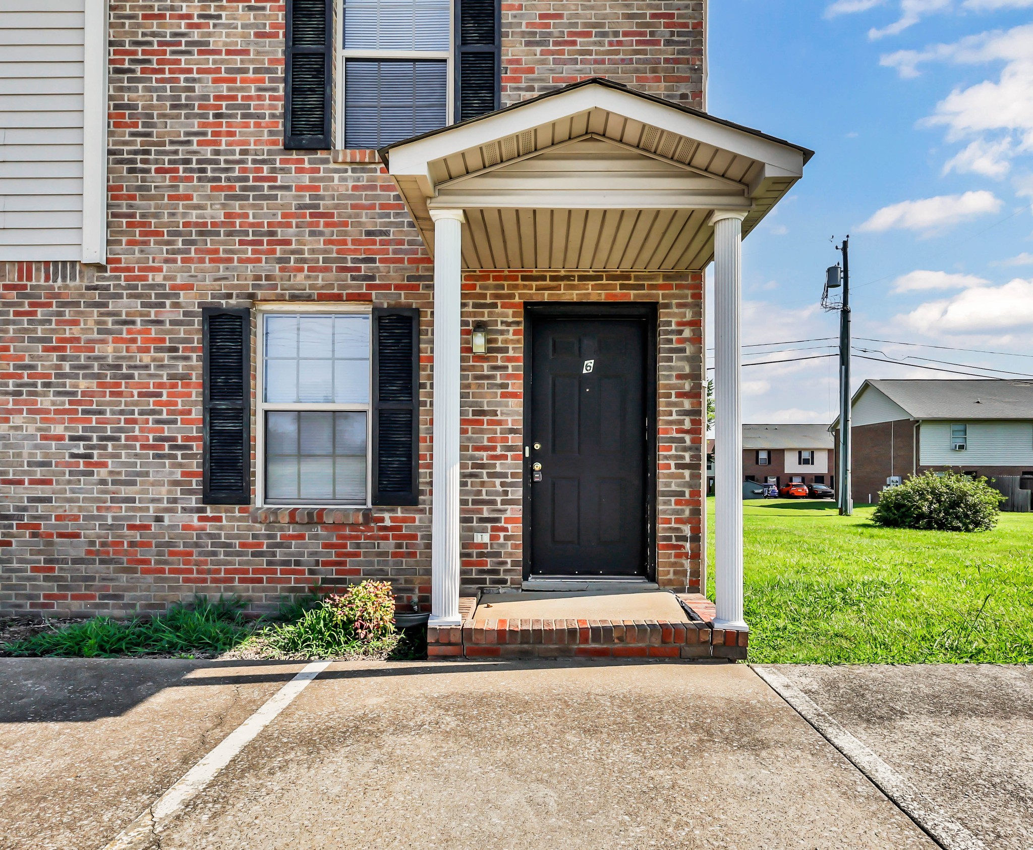 2451 Wilson Road, Unit 6 Clarksville, TN 37043 - Photo 1 of 21 a front view of a building with a garden and plants