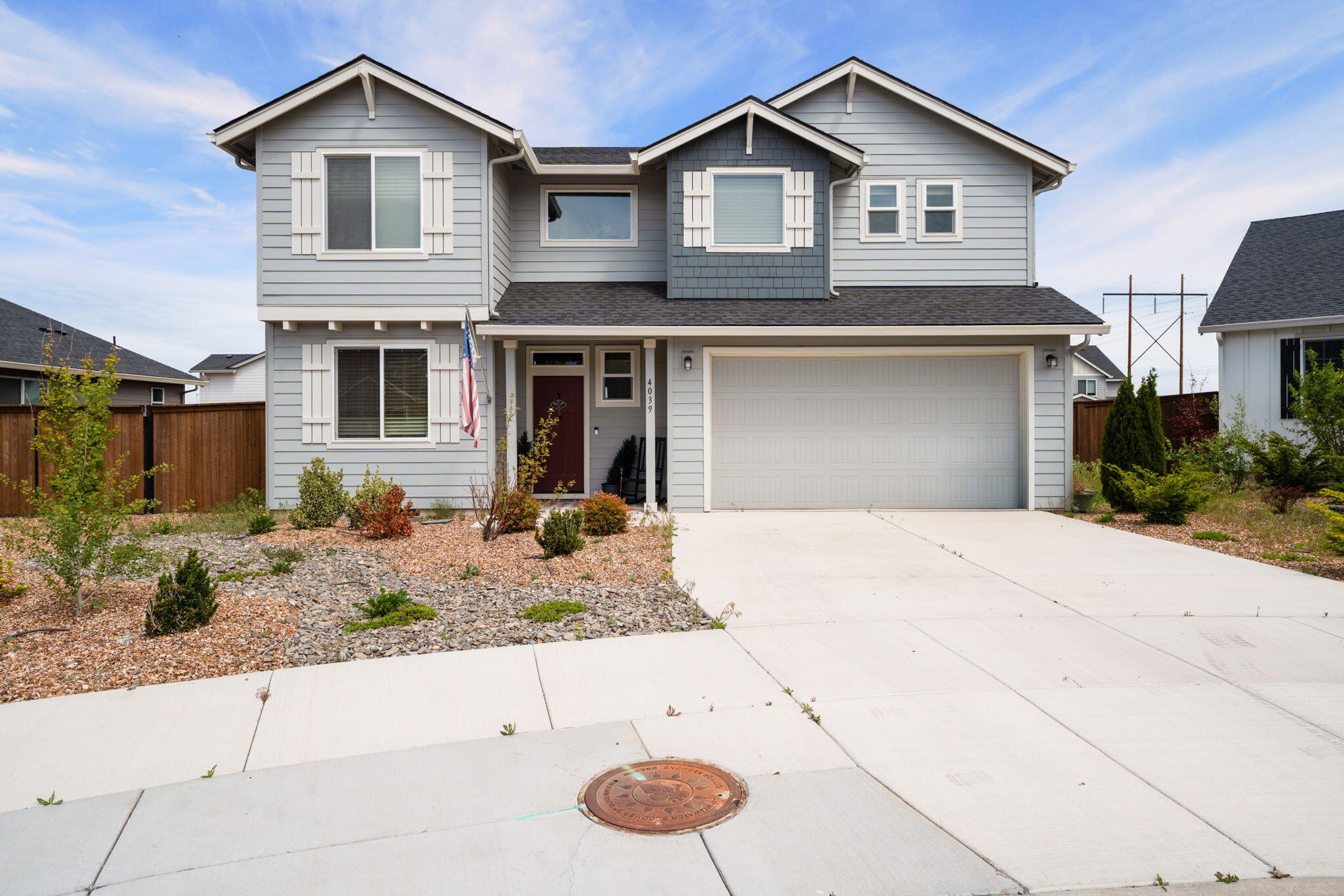 4039 Southwest Quartz Place Redmond, OR 97756 - Photo 3 of 44 a front view of a house with garden