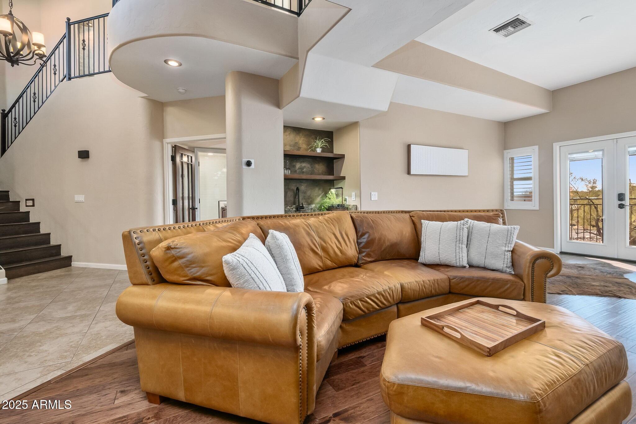6547 North Turnberry Drive Tucson, AZ 85718 - Photo 12 of 51 a large white couch sitting in a living room with kitchen and furniture