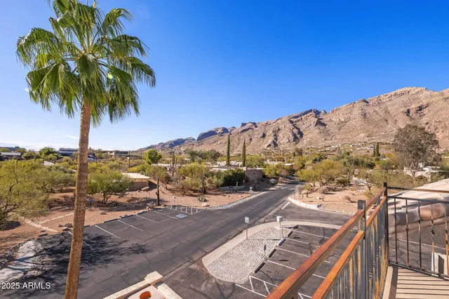 a spacious bedroom with a bed a couch and a window