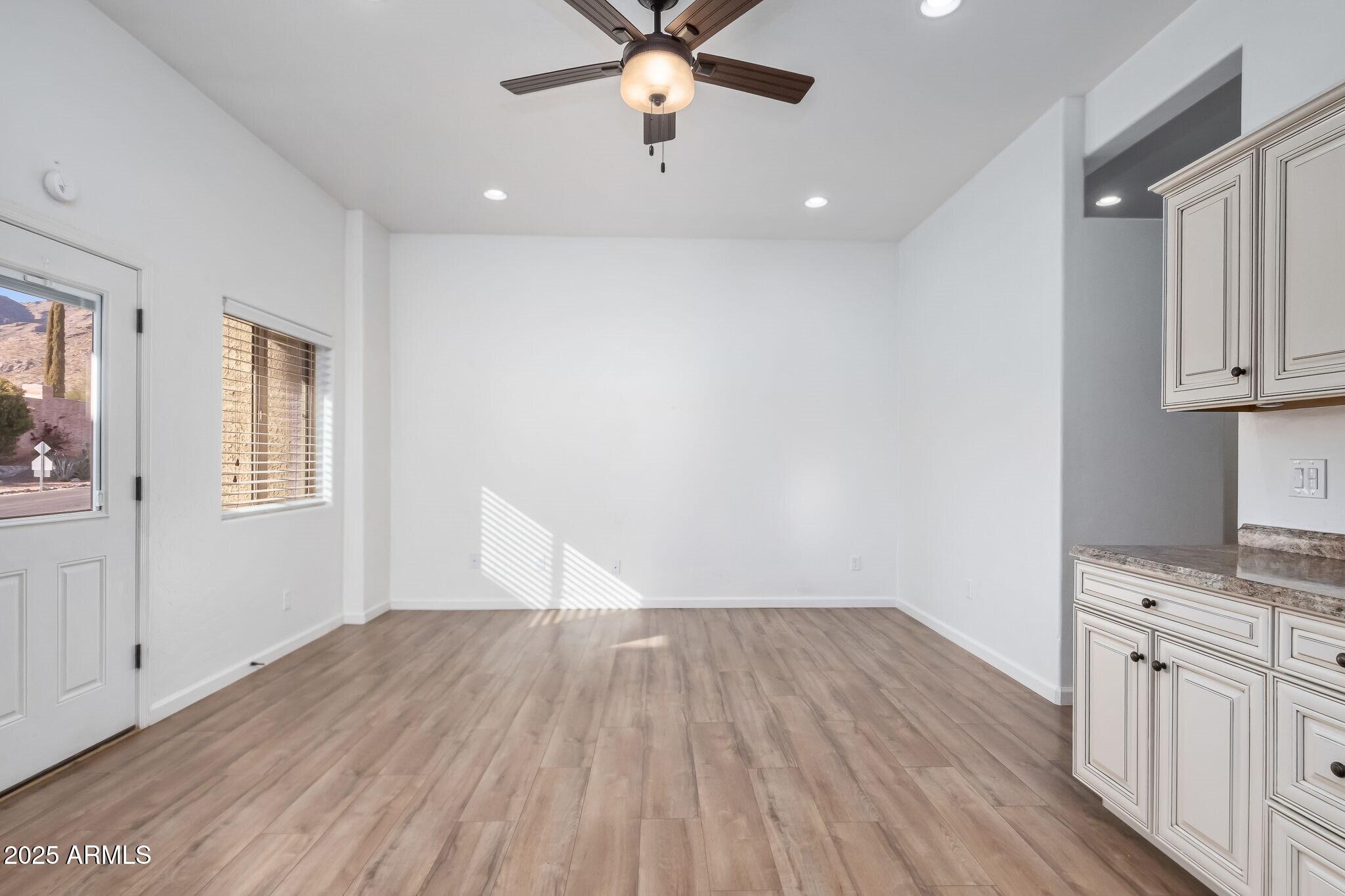 6547 North Turnberry Drive Tucson, AZ 85718 - Photo 33 of 51 wooden floor in an empty room with a window