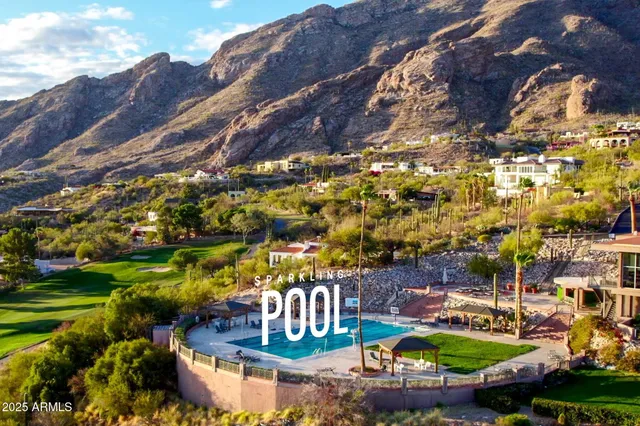 an aerial view of residential houses with outdoor space and swimming pool