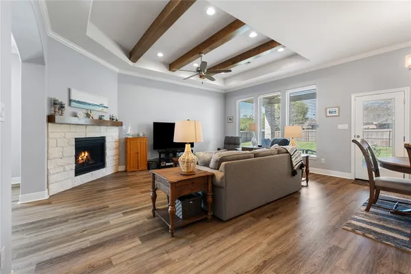 a living room with furniture a fireplace and a flat screen tv