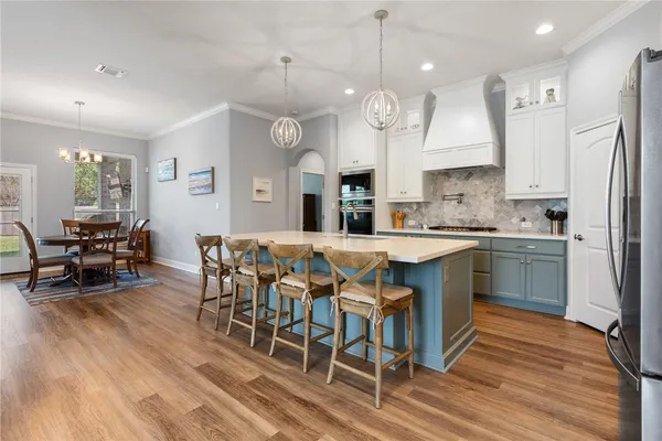 a large kitchen with a table and chairs