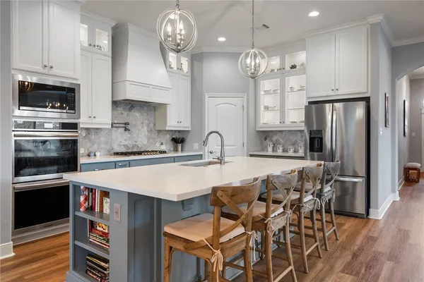 a very nice looking kitchen with granite countertop a stove oven and a refrigerator