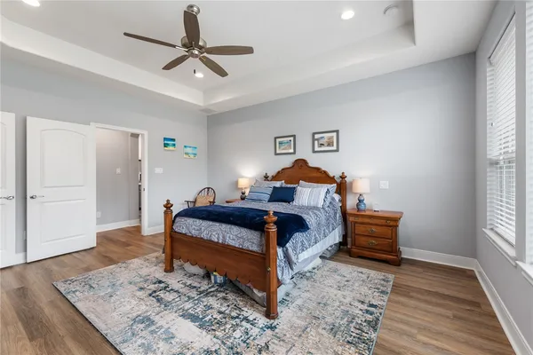 a bedroom with a bed and wooden floor