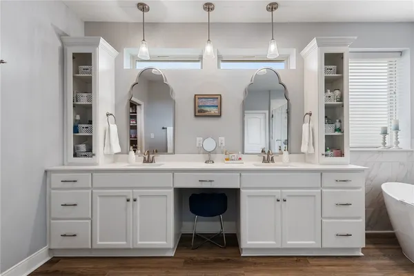 a spacious bathroom with a granite countertop sink and a mirror