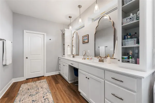 a spacious bathroom with a double vanity sink and mirror