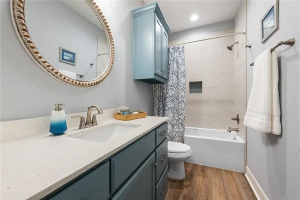 a bathroom with a sink a toilet and a mirror