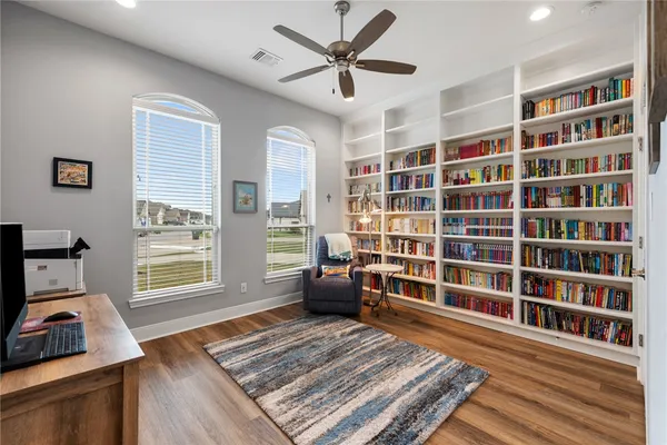 a view of a livingroom with furniture and a bookshelf