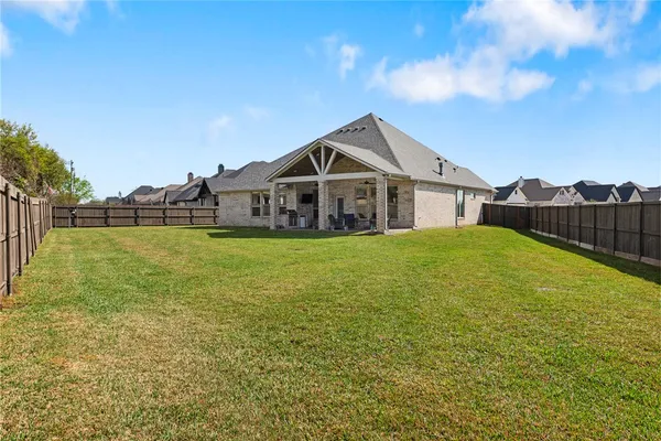 a house view with swimming pool in front of it