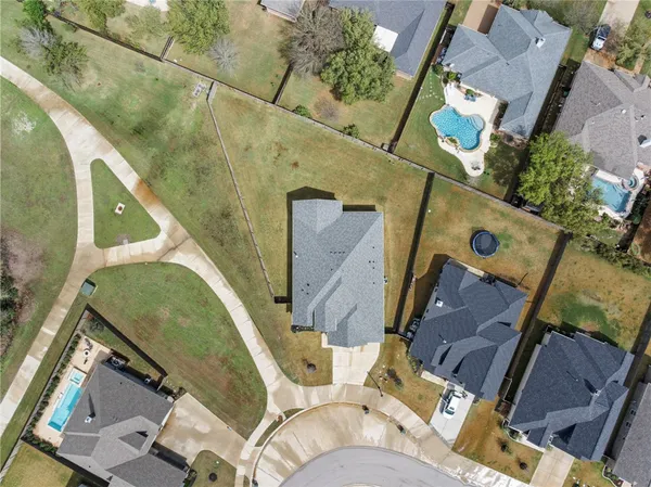 an aerial view of a house with a swimming pool