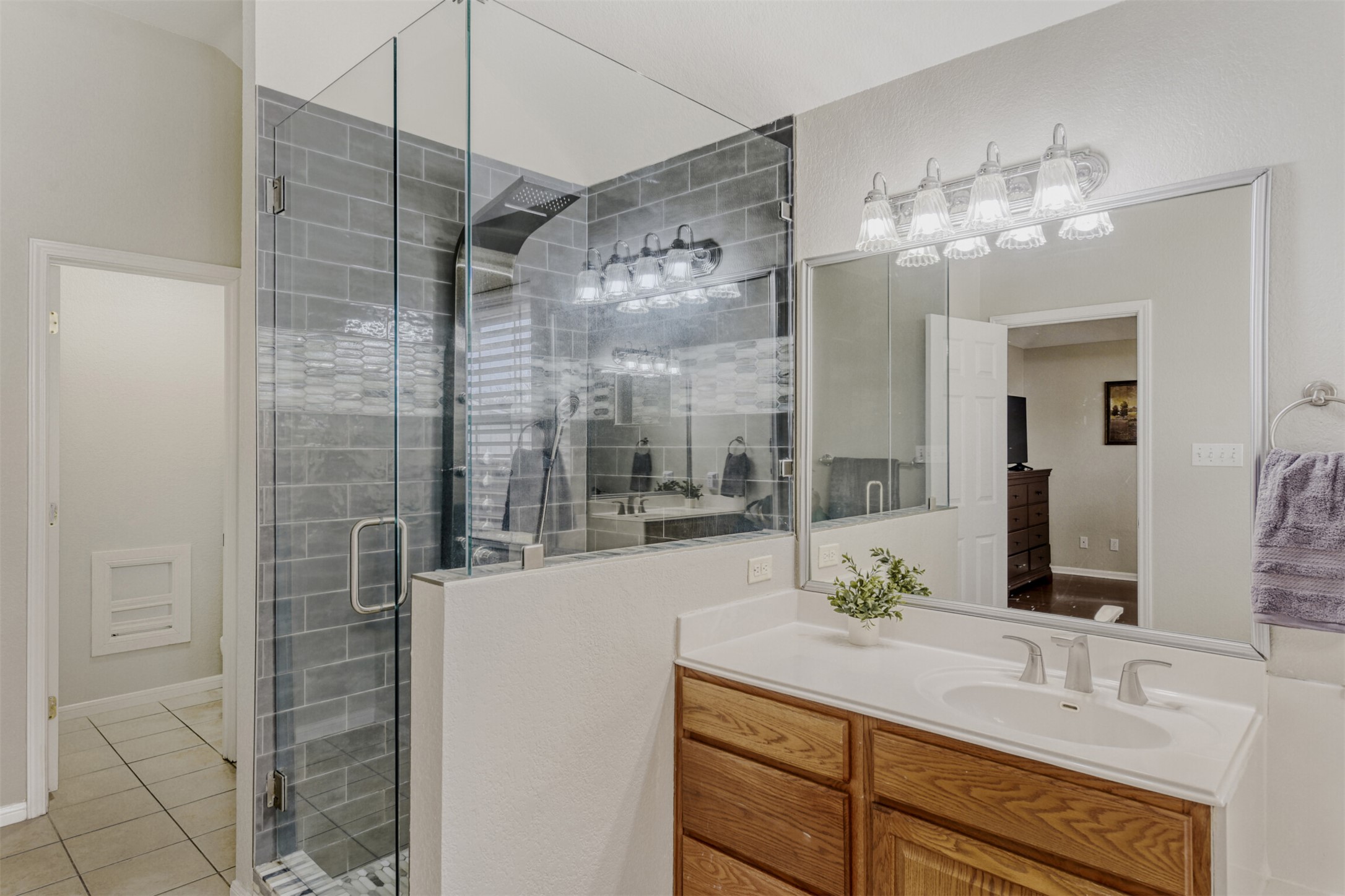 104 Spring Branch Bastrop, TX 78602 - Photo 25 of 32 Full bathroom featuring a shower stall, vanity, and light tile patterned floors