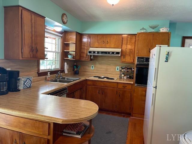 2393 Grit Road Hurt, VA 24563 - Photo 9 of 22 a kitchen with stainless steel appliances a refrigerator a sink a stove and wooden cabinets