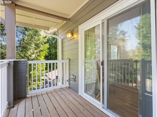 a view of a balcony with wooden floor