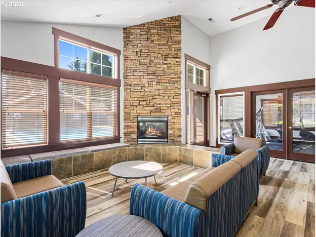 a living room with furniture and floor to ceiling windows