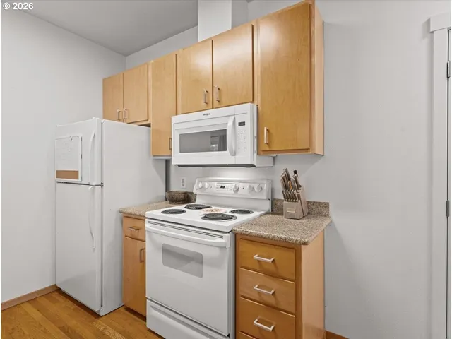 a kitchen with a refrigerator stove and sink