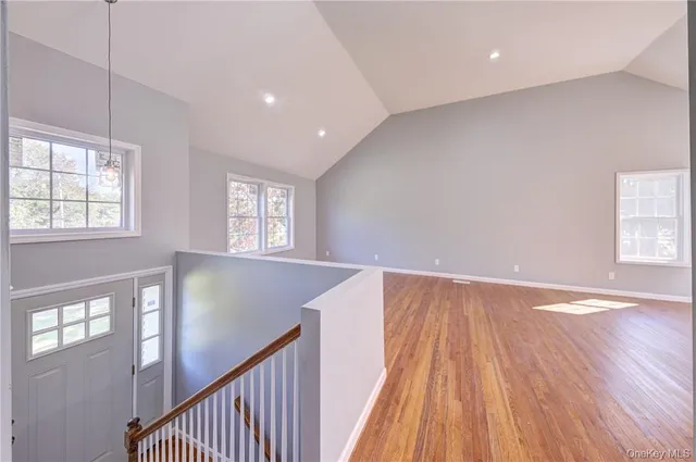 a kitchen with granite countertop a stove a sink and a refrigerator