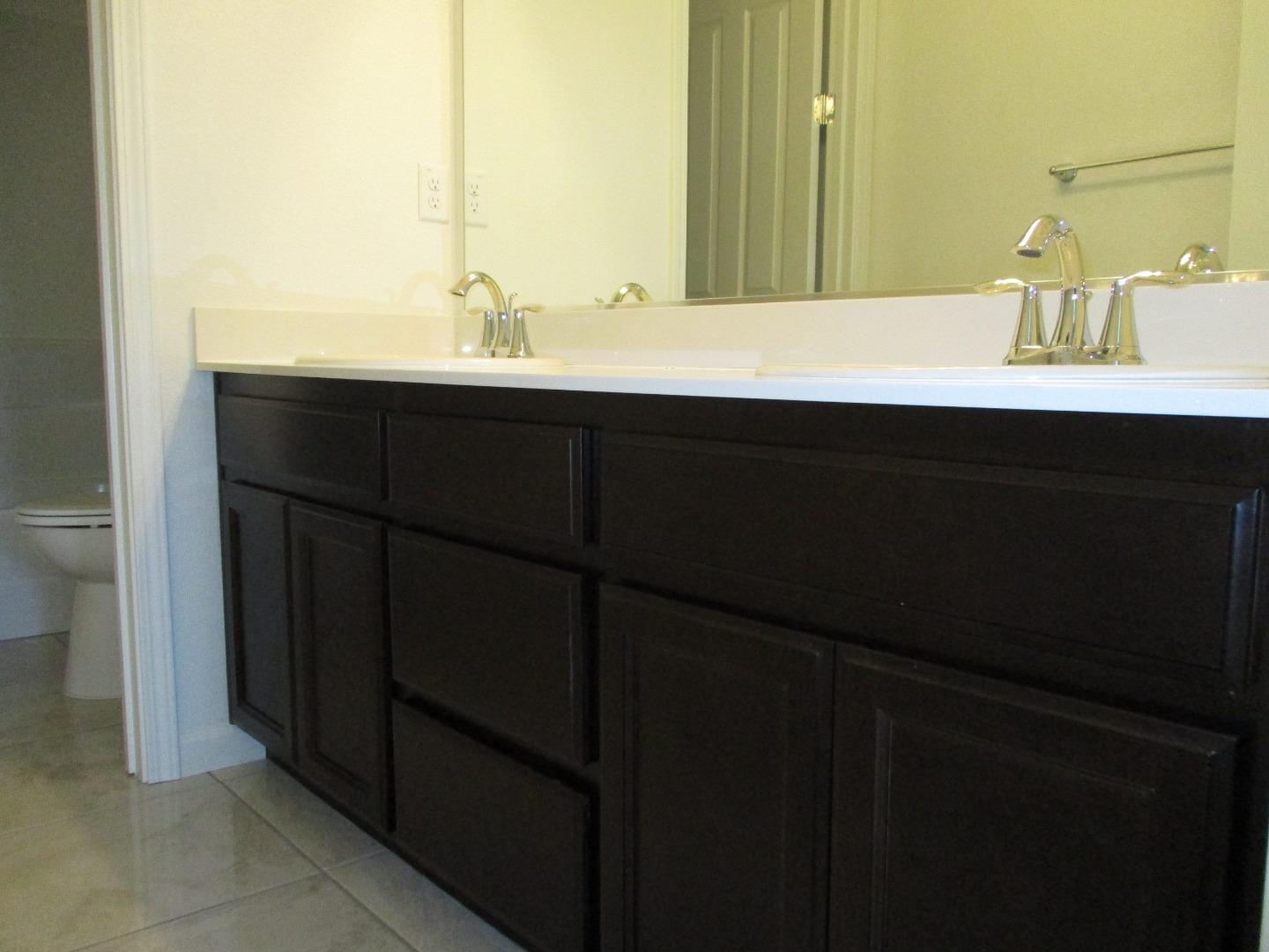 1027 Ruby Way Gilroy, CA 95020 - Photo 14 of 25 a bathroom with a double vanity sink and a mirror