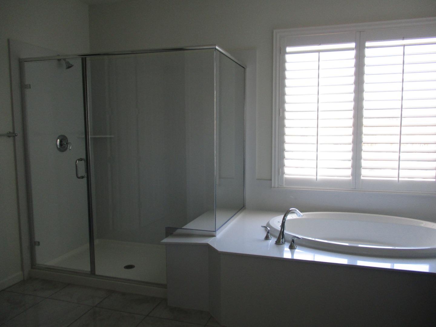 1027 Ruby Way Gilroy, CA 95020 - Photo 15 of 25 a bath room with a bath tub and a shower