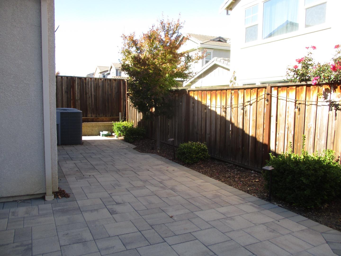 1027 Ruby Way Gilroy, CA 95020 - Photo 24 of 25 a view of backyard with potted plants and wooden fence