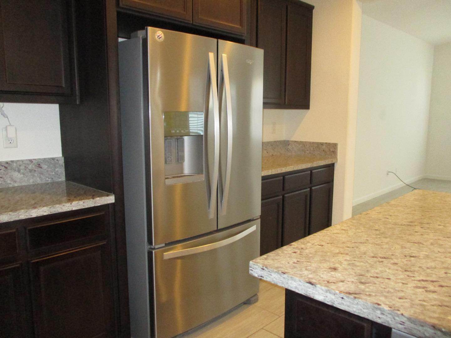 1027 Ruby Way Gilroy, CA 95020 - Photo 3 of 25 a kitchen with stainless steel appliances granite countertop a refrigerator and a sink