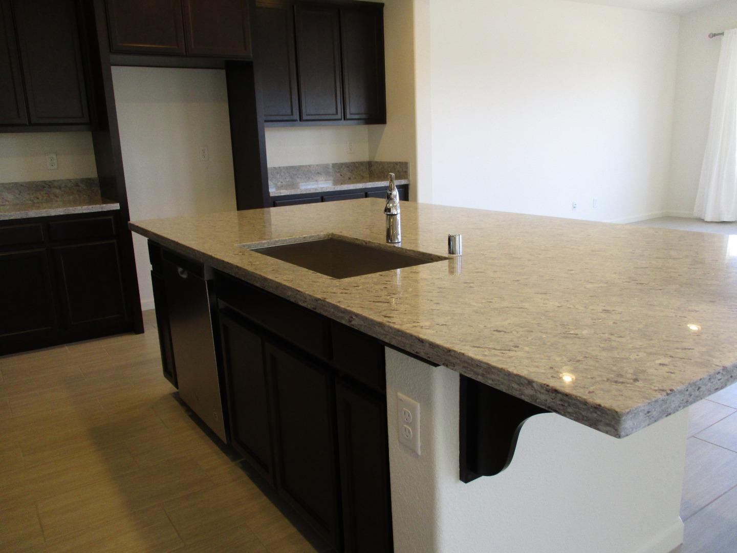 1027 Ruby Way Gilroy, CA 95020 - Photo 8 of 25 a kitchen with a sink and cabinets