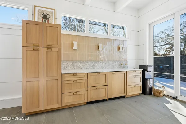 a kitchen with stainless steel appliances granite countertop a stove top oven a sink dishwasher and a refrigerator with wooden floor