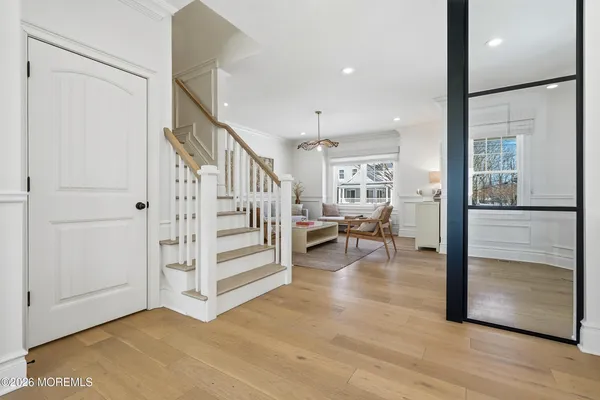 a view of a dining room with furniture a rug and wooden floor