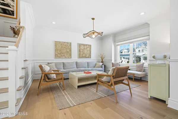 a view of a dining room with furniture and a chandelier